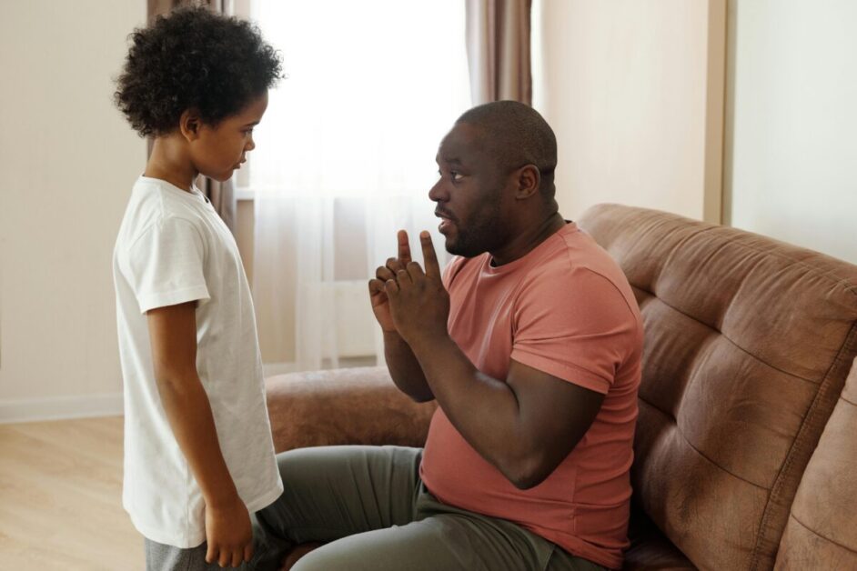 A father attentively communicating with his child, demonstrating the role of active listening and empathy to boost emotional intelligence.