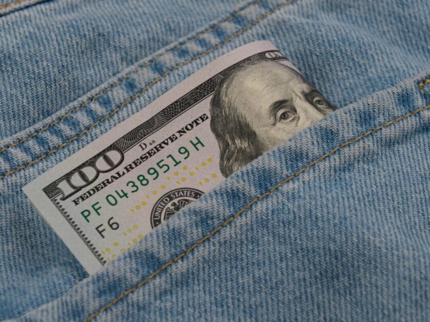 American One Hundred Dollar Banknote in Pocket of Blue Jeans, Symbolizing Inflation and Personal Finance