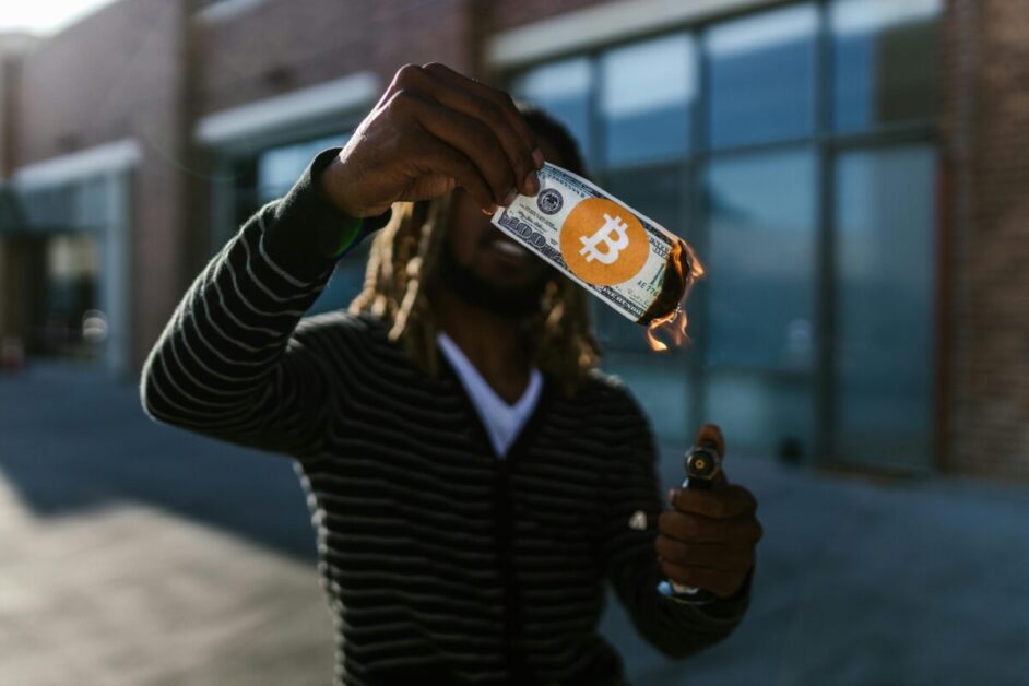 Man Burning Money Paper, Symbolizing the Erosion of Value Due to Inflation