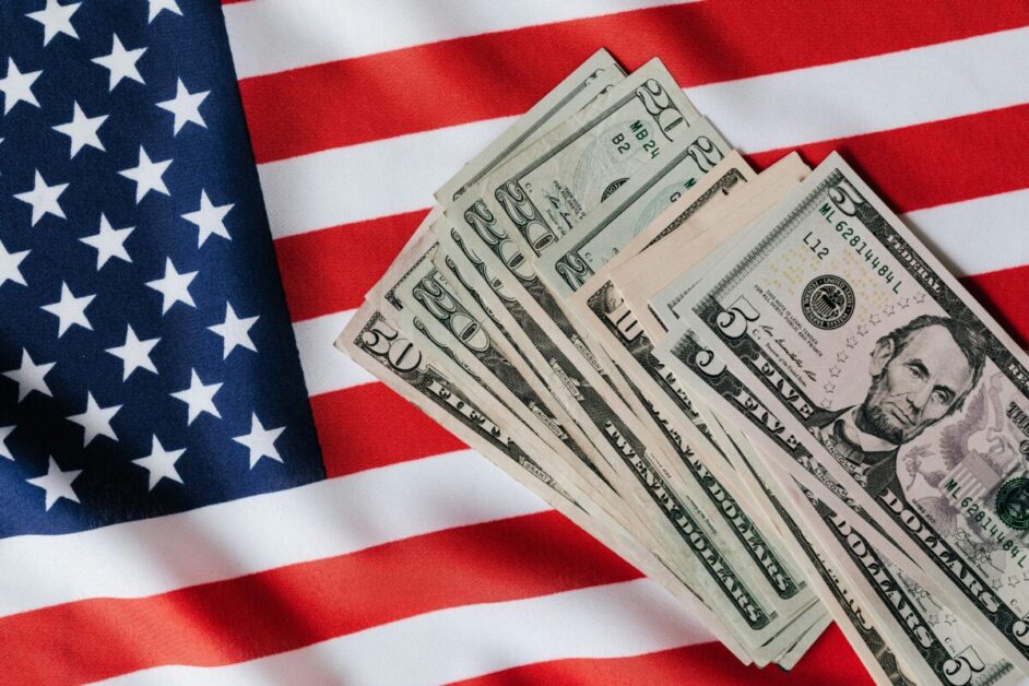 A visual representation of 'Capitalism and Wealth Building,' featuring U.S. currency displayed on an American flag backdrop, symbolizing economic opportunity and challenges."