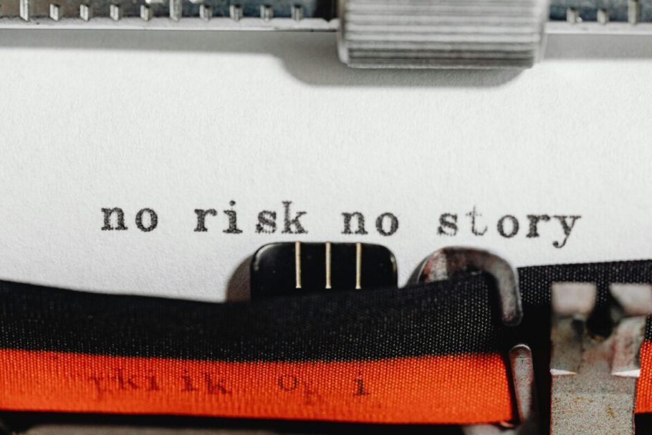 A close-up of a typewriter with the words 'no risk no story' typed on paper, illustrating the theme of a motivational short story.