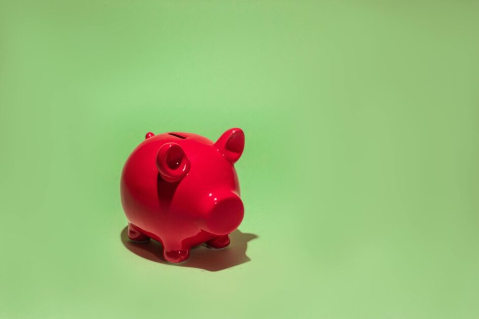 A bright red piggy bank, representing the idea of saving money and overcoming financial challenges.