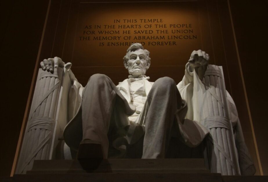 The iconic Lincoln Memorial statue in Washington DC with its inspirational inscription, representing leadership, perseverance, and career development through dedication to one's principles. The memorial's dramatic lighting emphasizes Lincoln's dignified seated pose and the monument's significance as a symbol of achievement and leadership excellence.